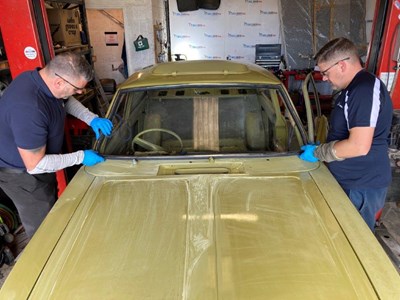 Tony Green and Dean Protor prepare a windscreen seal for a Morris Marina