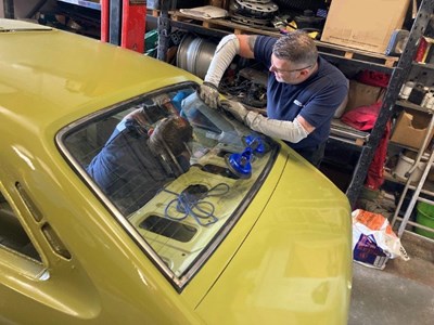 Tony Green fitting a rear screen on a Morris Marina